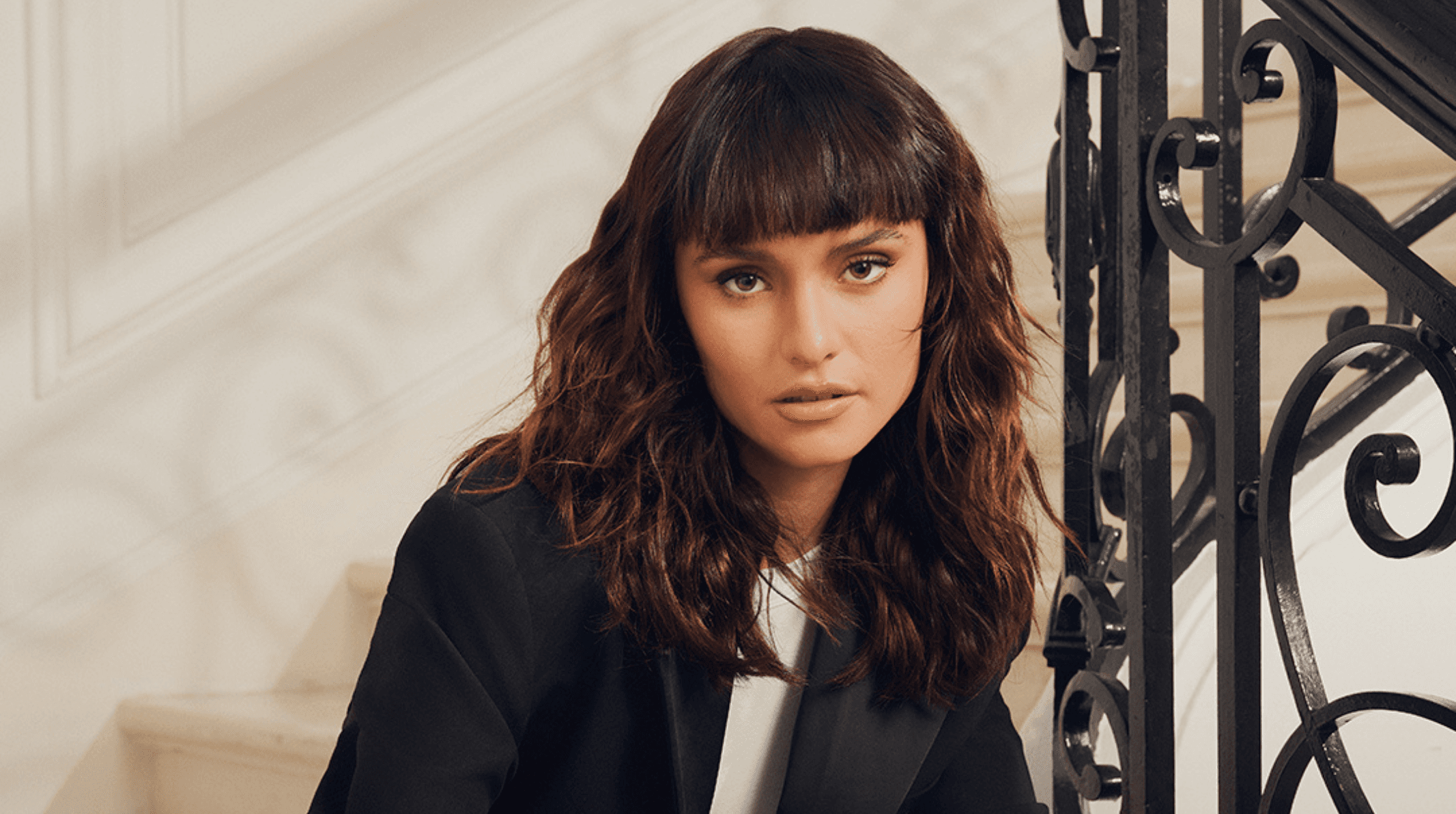 femme avec une coupe brune mi-longue ondulé avec une frange droite structurée